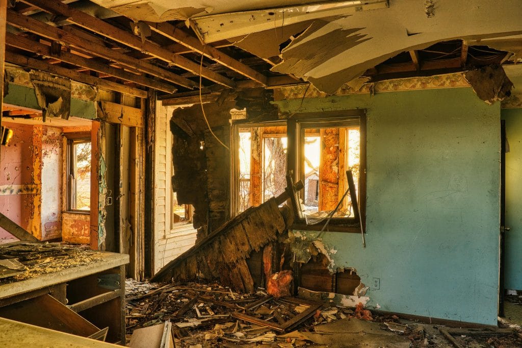 Interior of a dilapidated home undergoing demolition, showcasing exposed walls and debris, illustrating the process of selective demolition for renovation projects in Houston.